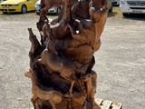 a sculpture made of wood on a pallet in a parking lot