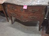 a marble top dresser with a marble top on it