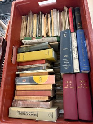 many books in a red box on a table