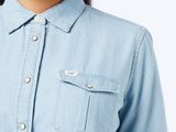 an image of a woman wearing a denim shirt