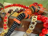 a wooden box with many different colored bracelets on it