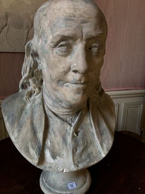 a bust of a man with long hair on a table