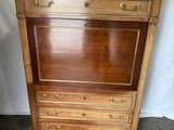 an image of a wooden cabinet with drawers on top of it