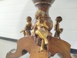a statue of a boy sitting on top of a wooden table