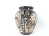 a vase with a painting on it sitting on a table