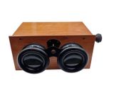 an image of a pair of binoculars sitting on top of a wooden box