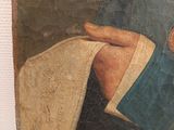 a painting of a man reading a book on the wall