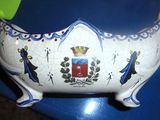 a ceramic bowl with a coat of arms and a crown on it