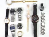 a lot of watches that are laying out on the table