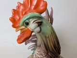a figurine of a rooster with a red head