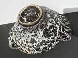 a black and white rock with a ring on top of it