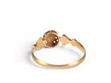 a close up of a gold ring with a brown stone