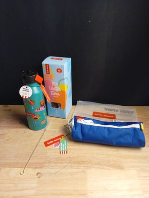 une brosse à dents, du dentifrice, un tube de dentifrice et un porte-dentifrice posés sur une table