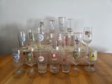 a lot of wine glasses sitting on a wooden table