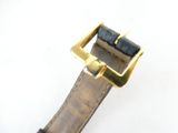 a close up of a watch on a white surface