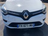 the front end of a white car parked in a parking lot