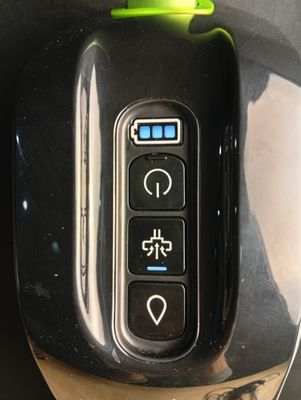a close up of a computer mouse with a green button