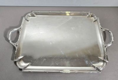 an antique silver tray with handles and handles on a table