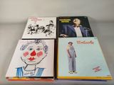 three books with drawings on them sitting on top of a table