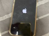 an iphone that is sitting on a bed next to a bottle of water