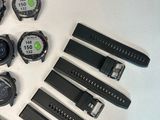 many different types of watches on a white table