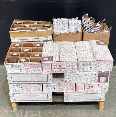 several boxes of mail are stacked on a pallet in front of a black wall