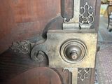 a close up of a door handle on a wooden door