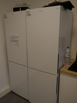 a white refrigerator in the corner of a kitchen