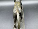 bronze sculpture of a lion on a base