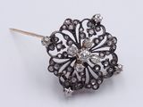 a close up of a black and white diamond broochle