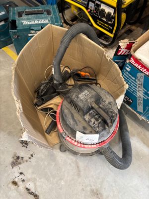 a box full of tools sitting on the floor in the garage