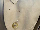 a close up of a coat with buttons on it