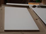 two pieces of white paper on a cardboard box