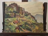 un tableau posé sur un chevalet, avec en arrière-plan un tableau représentant un village