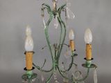 a person that is holding a chandelier in their hand