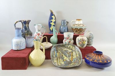 many different types of vases sitting on a shelf