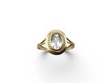 a gold ring with a white topaz stone in the center