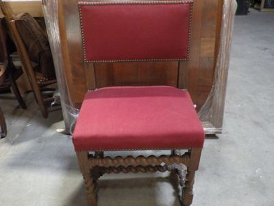 a red chair that is sitting in the middle of a room