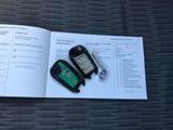 two cell phones sitting on top of an open book