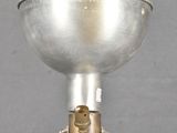 a silver light that is on top of a metal stand