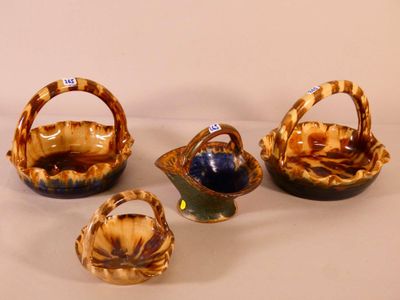 four pieces of pottery sitting on top of a white surface