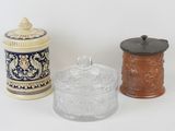 three glass containers sitting next to each other on a white surface