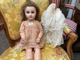 a doll that is sitting on a chair in a room