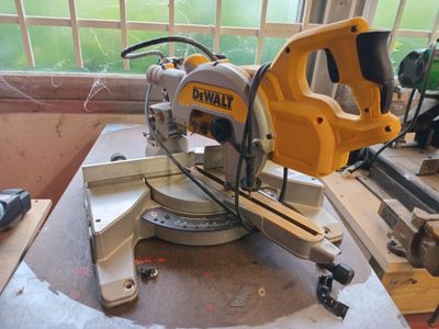 a yellow and black circular saw on a table