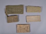 several pieces of cloth are laid out on a white surface