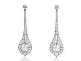 a pair of pearl and diamond earrings