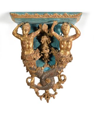 a gold and blue vase with two statues on it