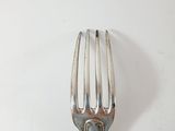 a fork that is sitting on top of a white table