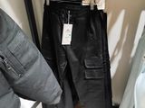 a rack with a pair of pants and a jacket on it