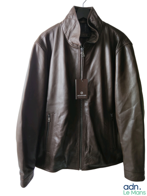 brown leather jacket hanging on a hanger on a white wall